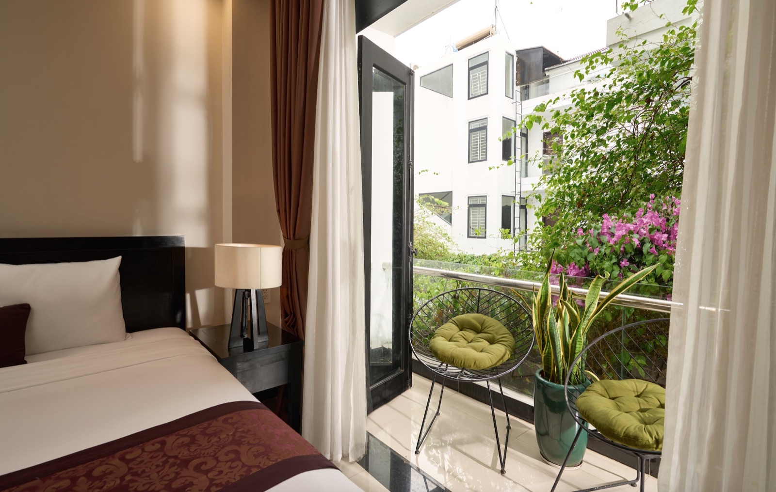 A room with its own private balcony overlooking bougainvillea