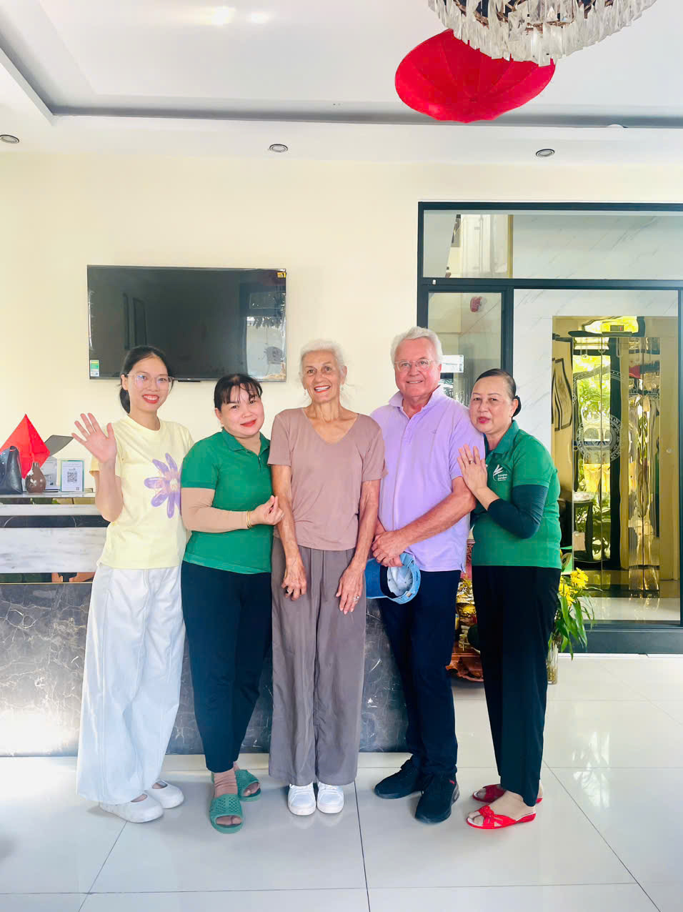 Guests and staff posing together in the lobby