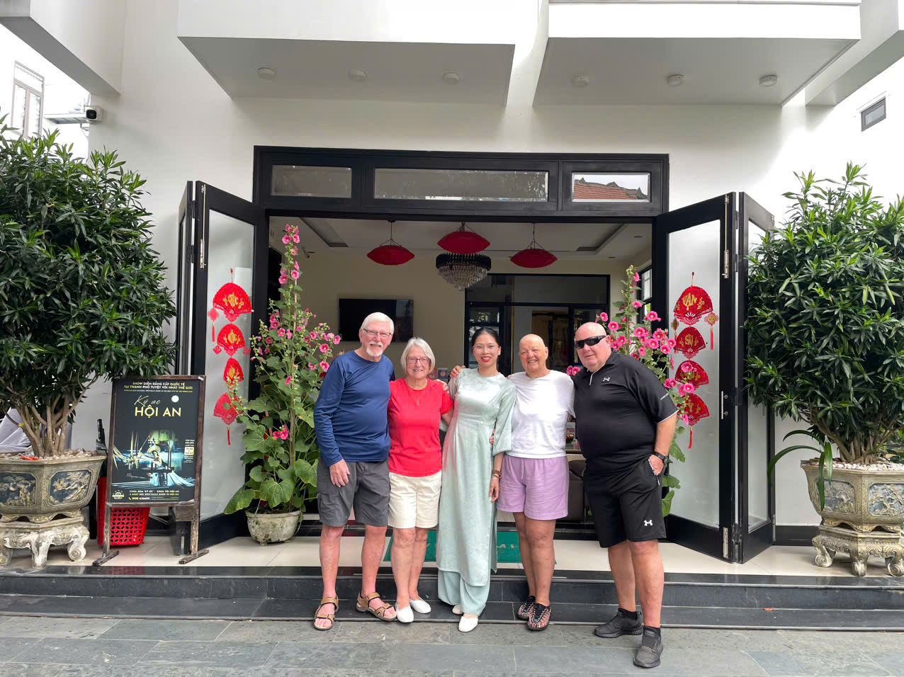 Guests and staff at the entrance decorated for Tet